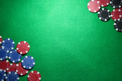 Photo of Poker chips on green table, flat lay. Space for text