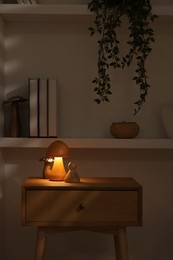 Photo of Night light on bedside table and other decor in room