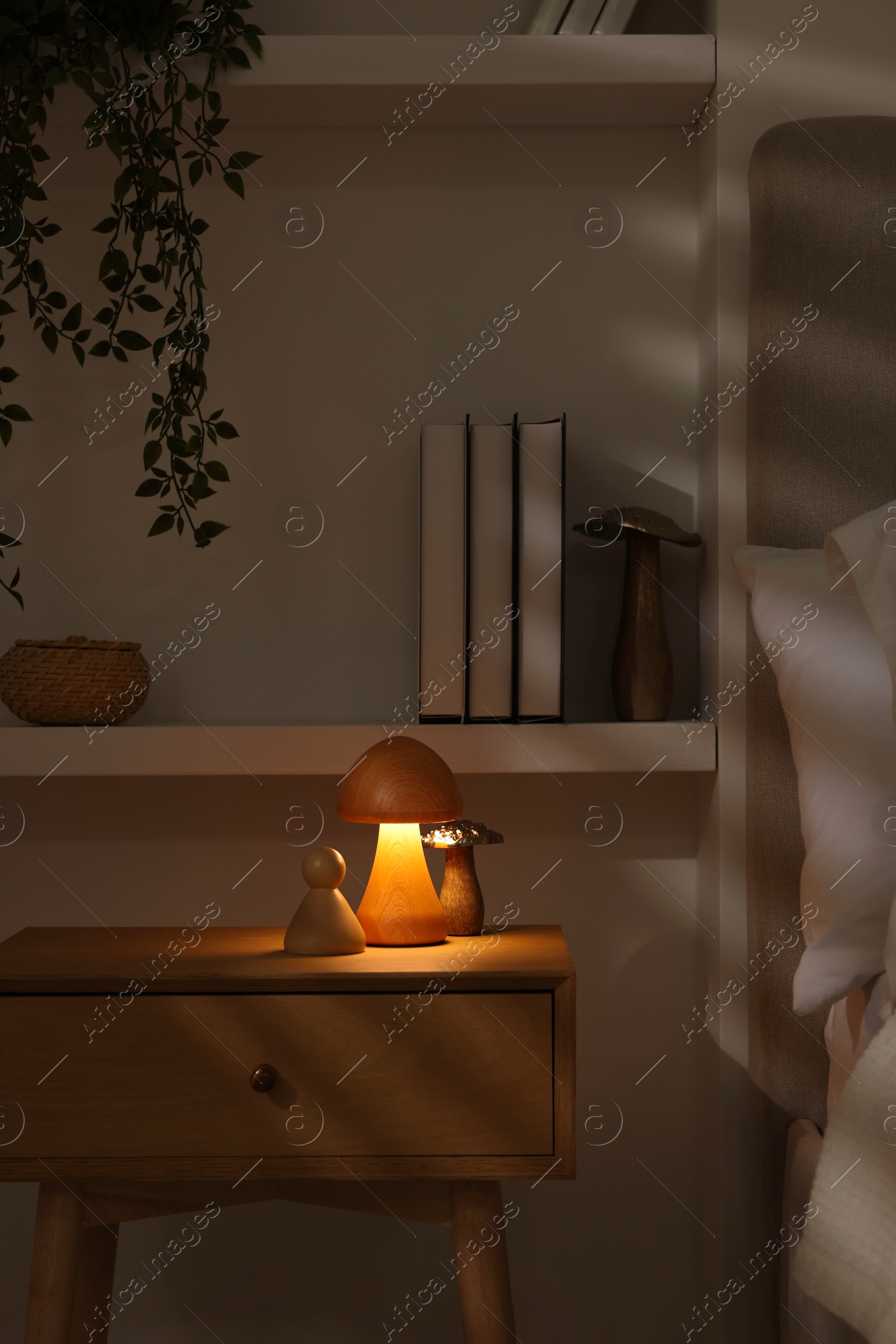 Photo of Night light on bedside table and other decor in room