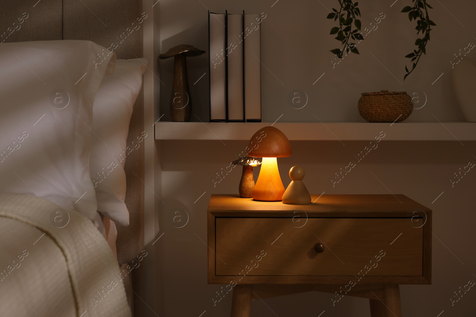 Photo of Stylish living room interior with bed, bedside table and night light