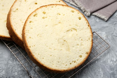 Photo of Delicious cut sponge cake on grey textured table