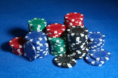 Photo of Poker game. Casino chips on blue table