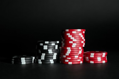 Photo of Poker game. Casino chips on black background