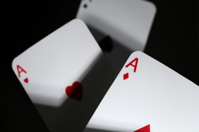 Photo of Poker game. Playing cards on black background, closeup