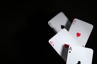 Photo of Poker game. Playing cards on black background, closeup. Space for text