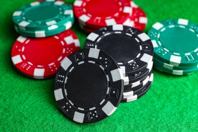 Photo of Poker game. Casino chips on green table, closeup