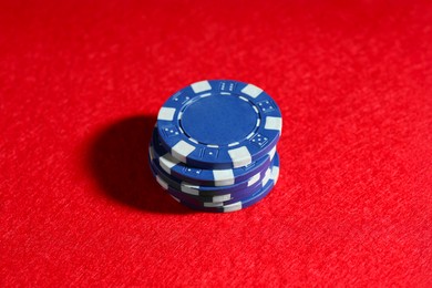 Photo of Poker game. Casino chips on red table