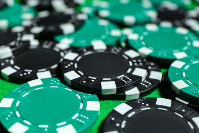 Photo of Poker game. Casino chips on green table, closeup