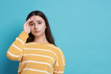 Photo of Stressful student before exam on light blue background, space for text