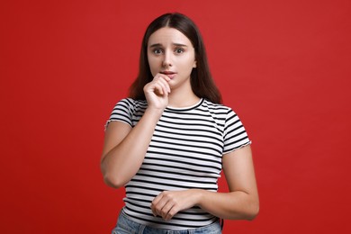 Photo of Stressful student before exam on red background