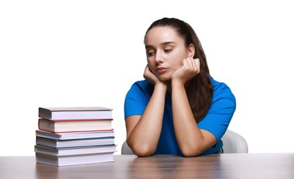 Photo of Young student with stack of books having stress before exam at wooden table isolated on white