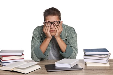 Photo of Tired student before exam at table among books against white background