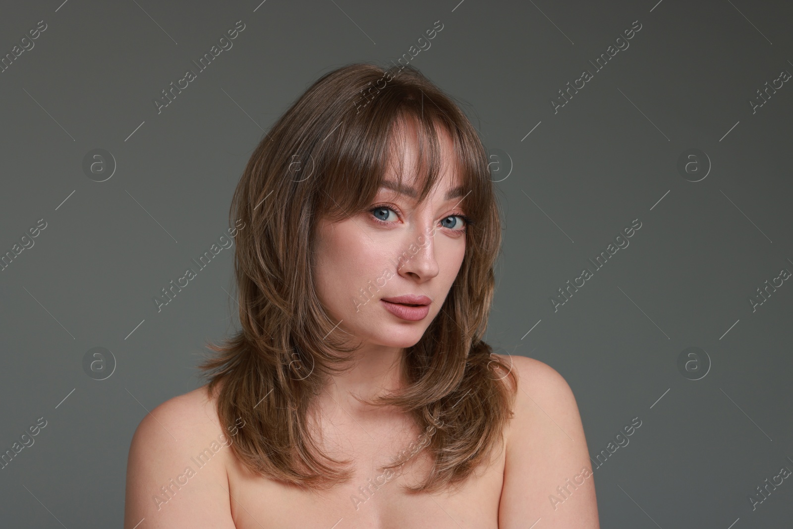 Photo of Attractive woman with stylish haircut on grey background