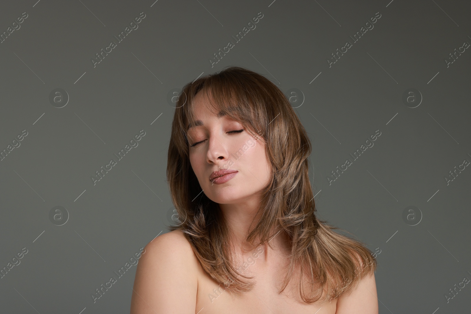 Photo of Attractive woman with stylish haircut on grey background