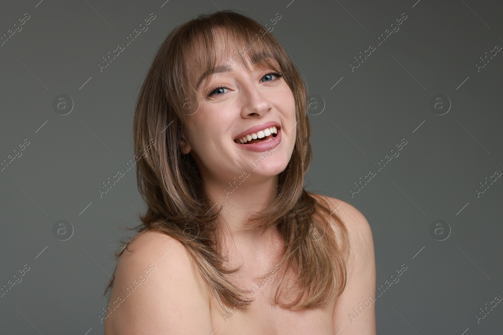 Photo of Attractive woman with stylish haircut on grey background