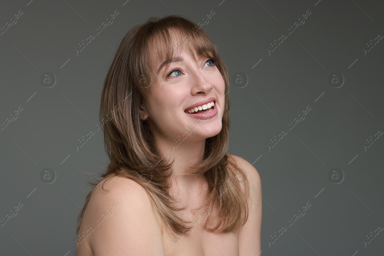 Photo of Attractive woman with stylish haircut on grey background