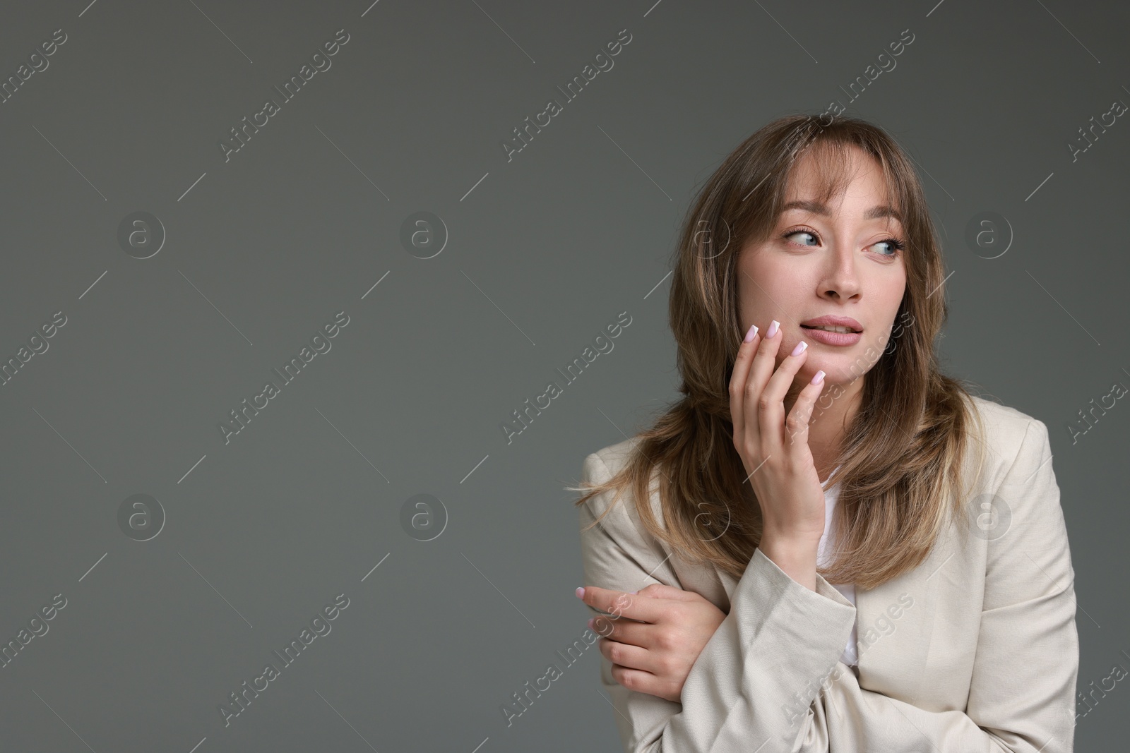 Photo of Attractive woman with stylish haircut on grey background, space for text