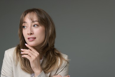 Photo of Attractive woman with stylish haircut on grey background, space for text