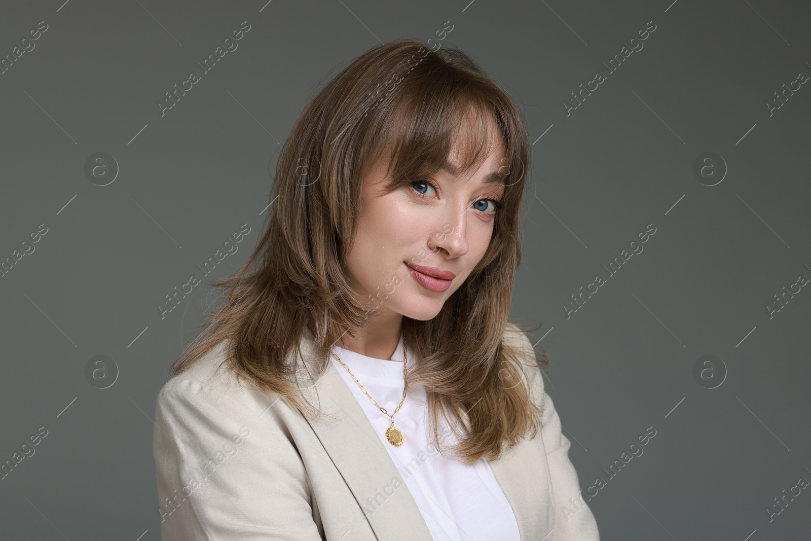 Photo of Attractive woman with stylish haircut on grey background