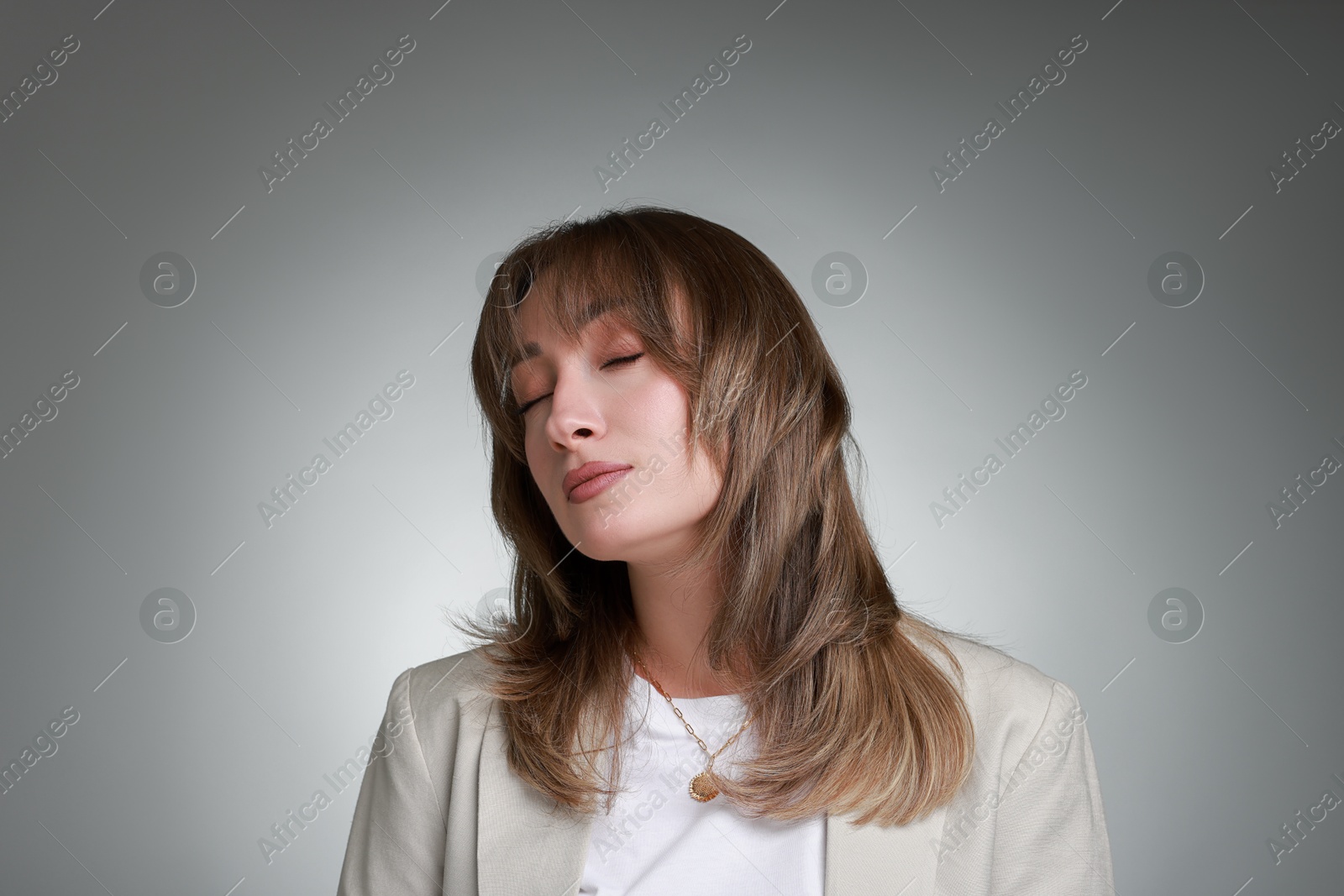 Photo of Attractive woman with stylish haircut on grey gradient background