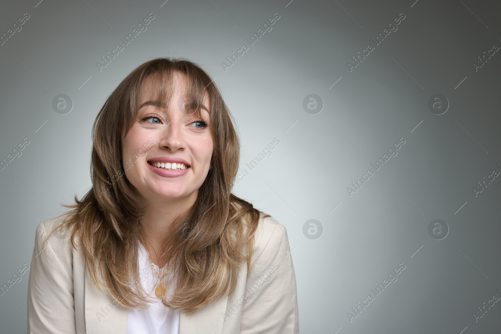 Photo of Attractive woman with stylish haircut on grey gradient background, space for text