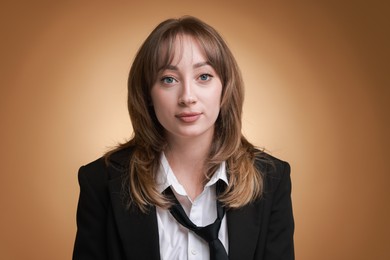 Photo of Attractive woman with stylish haircut on brown gradient background