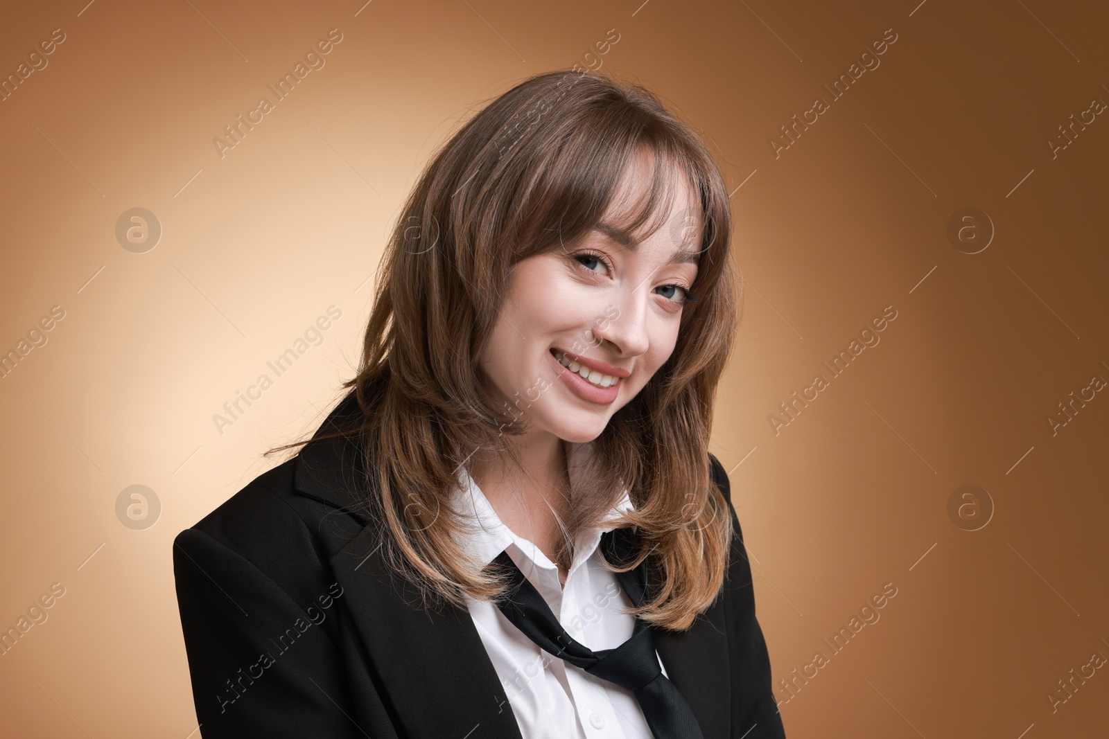 Photo of Attractive woman with stylish haircut on brown gradient background