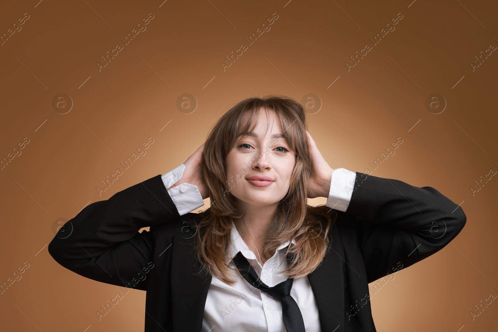 Photo of Attractive woman with stylish haircut on brown gradient background