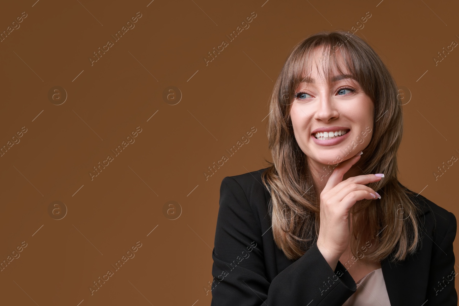 Photo of Attractive woman with stylish haircut on brown background, space for text