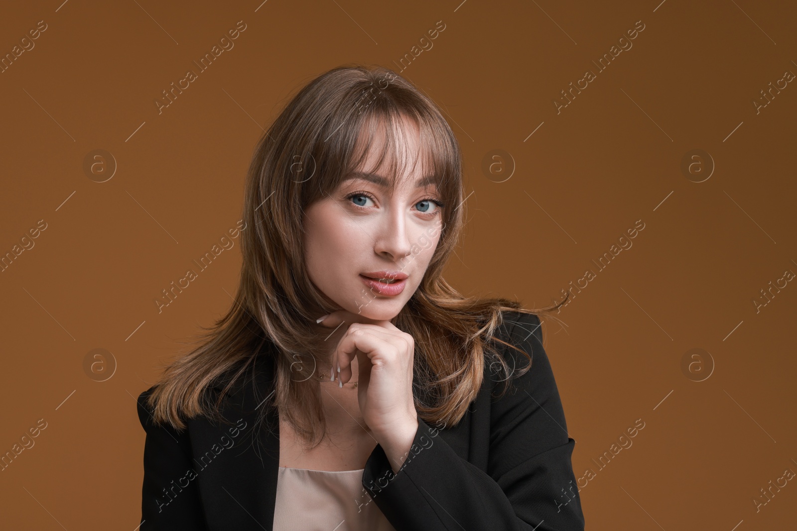 Photo of Attractive woman with stylish haircut on brown background