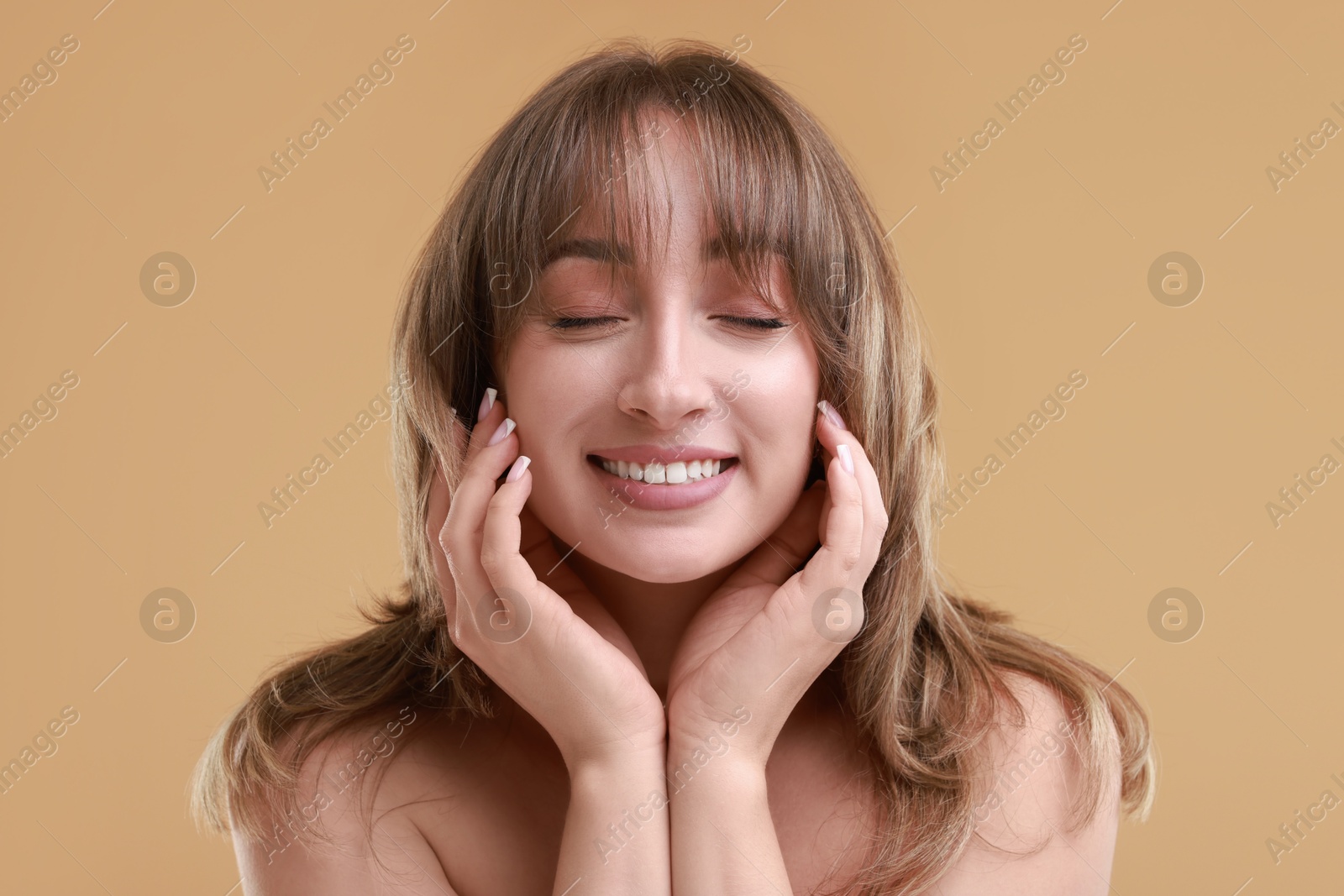 Photo of Attractive woman with stylish haircut on beige background