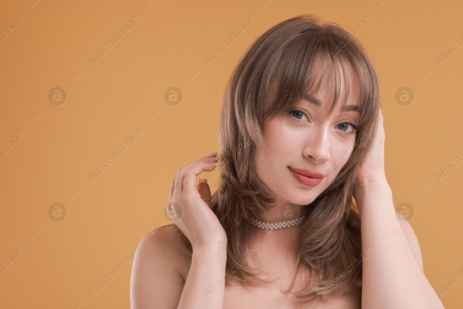 Photo of Attractive woman with stylish haircut on beige background