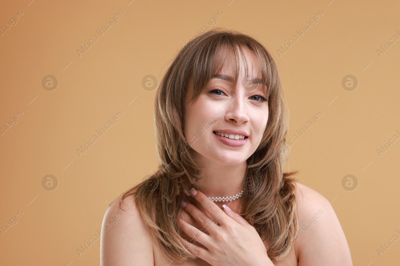 Photo of Attractive woman with stylish haircut on beige background