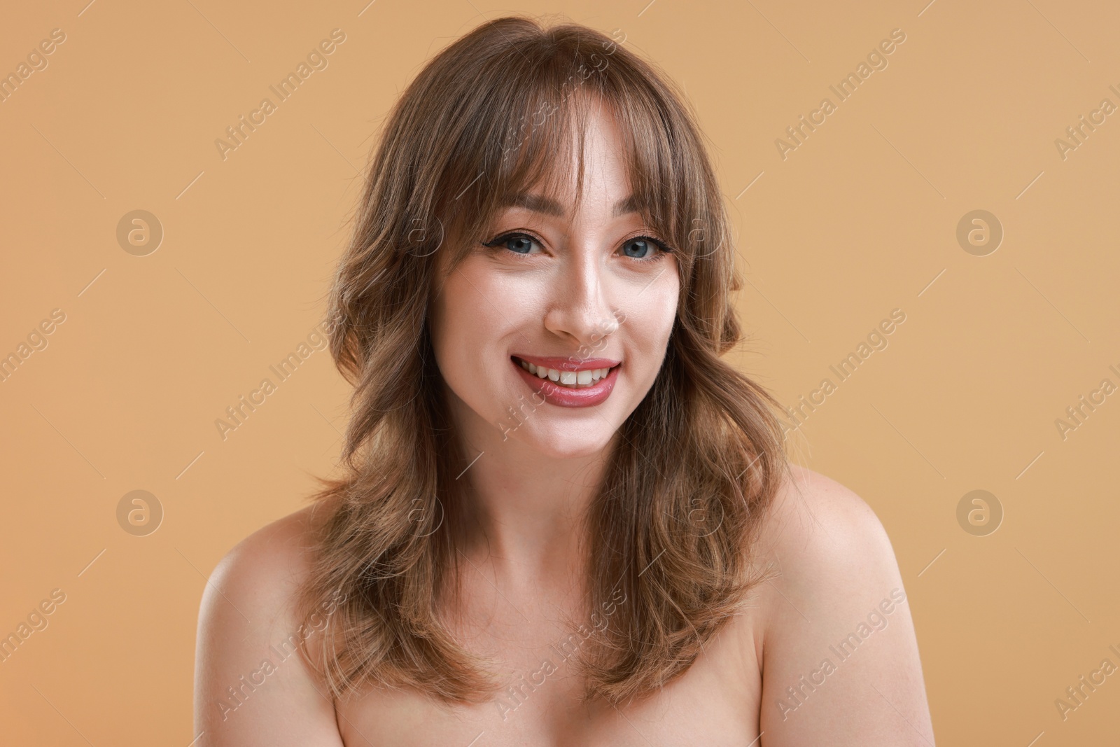 Photo of Attractive woman with stylish haircut on beige background