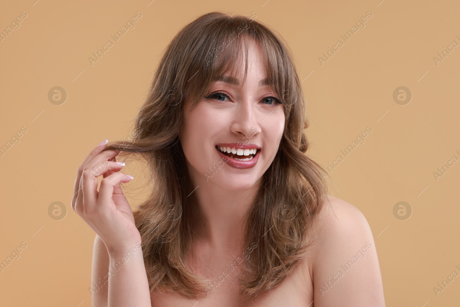 Photo of Attractive woman with stylish haircut on beige background