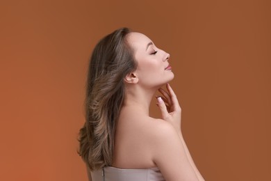 Photo of Attractive woman with stylish haircut on brown background