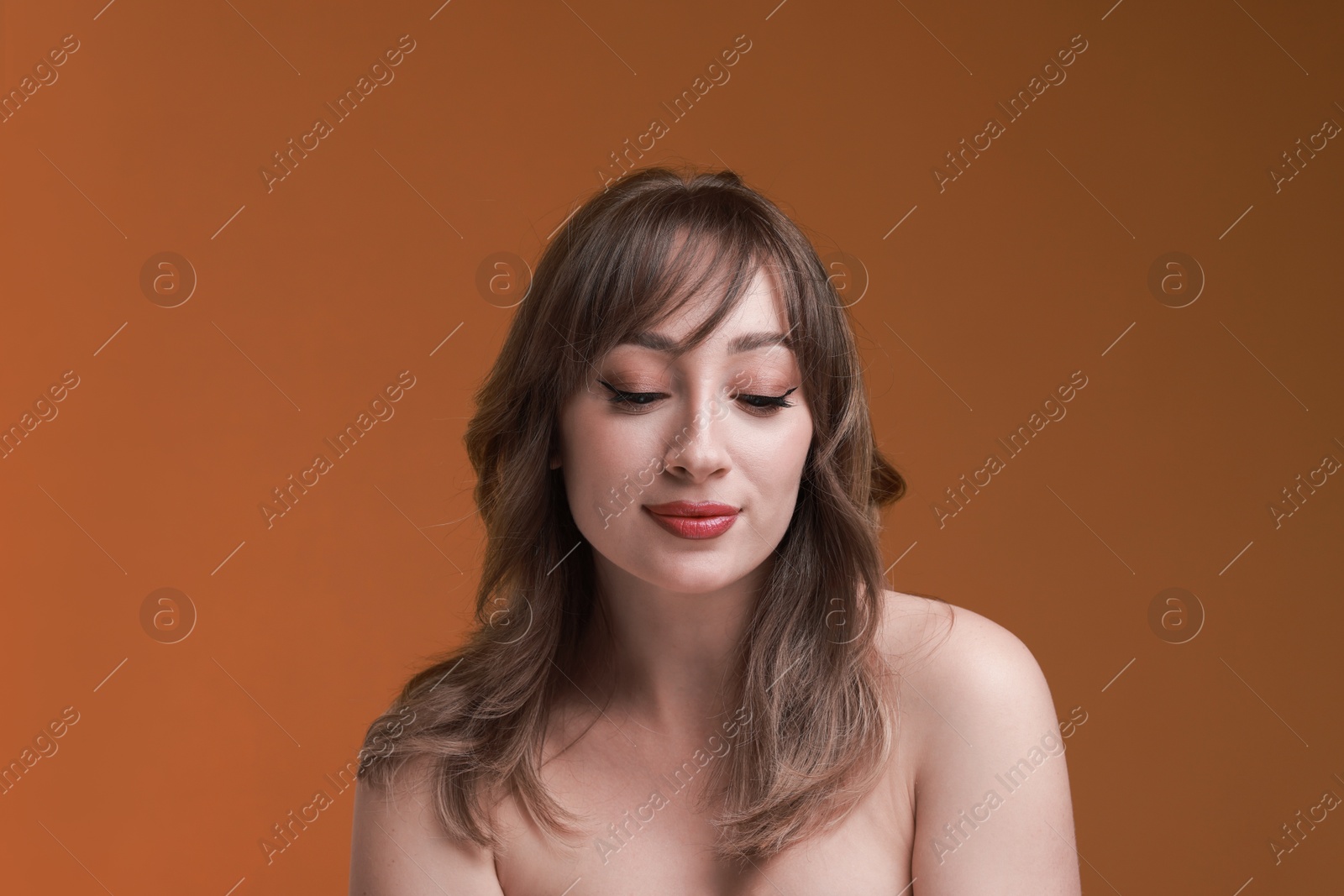 Photo of Attractive woman with stylish haircut on brown background