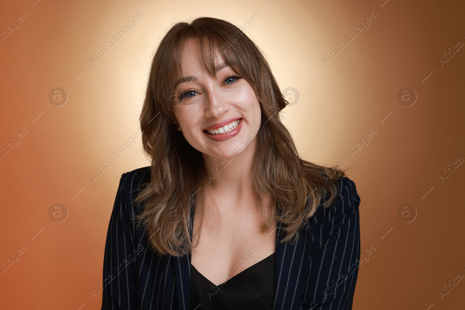 Photo of Attractive woman with stylish haircut on brown gradient background