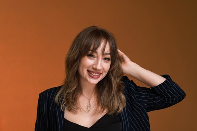 Photo of Attractive woman with stylish haircut on brown background