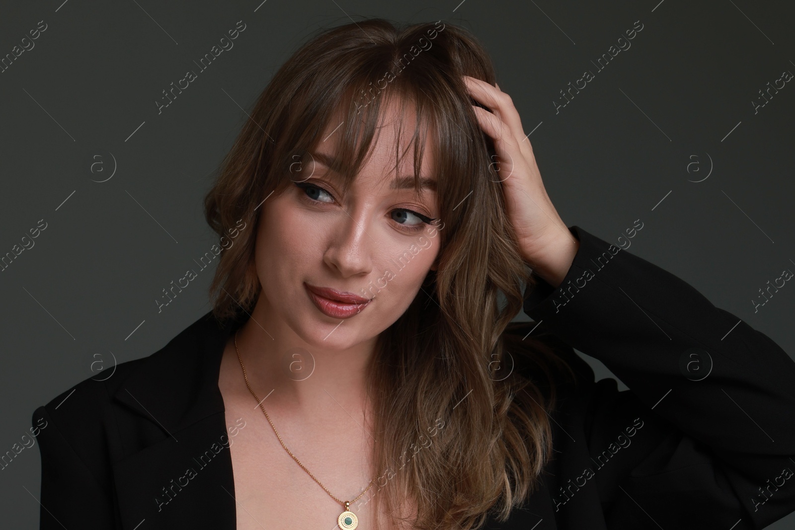 Photo of Attractive woman with stylish haircut on grey background