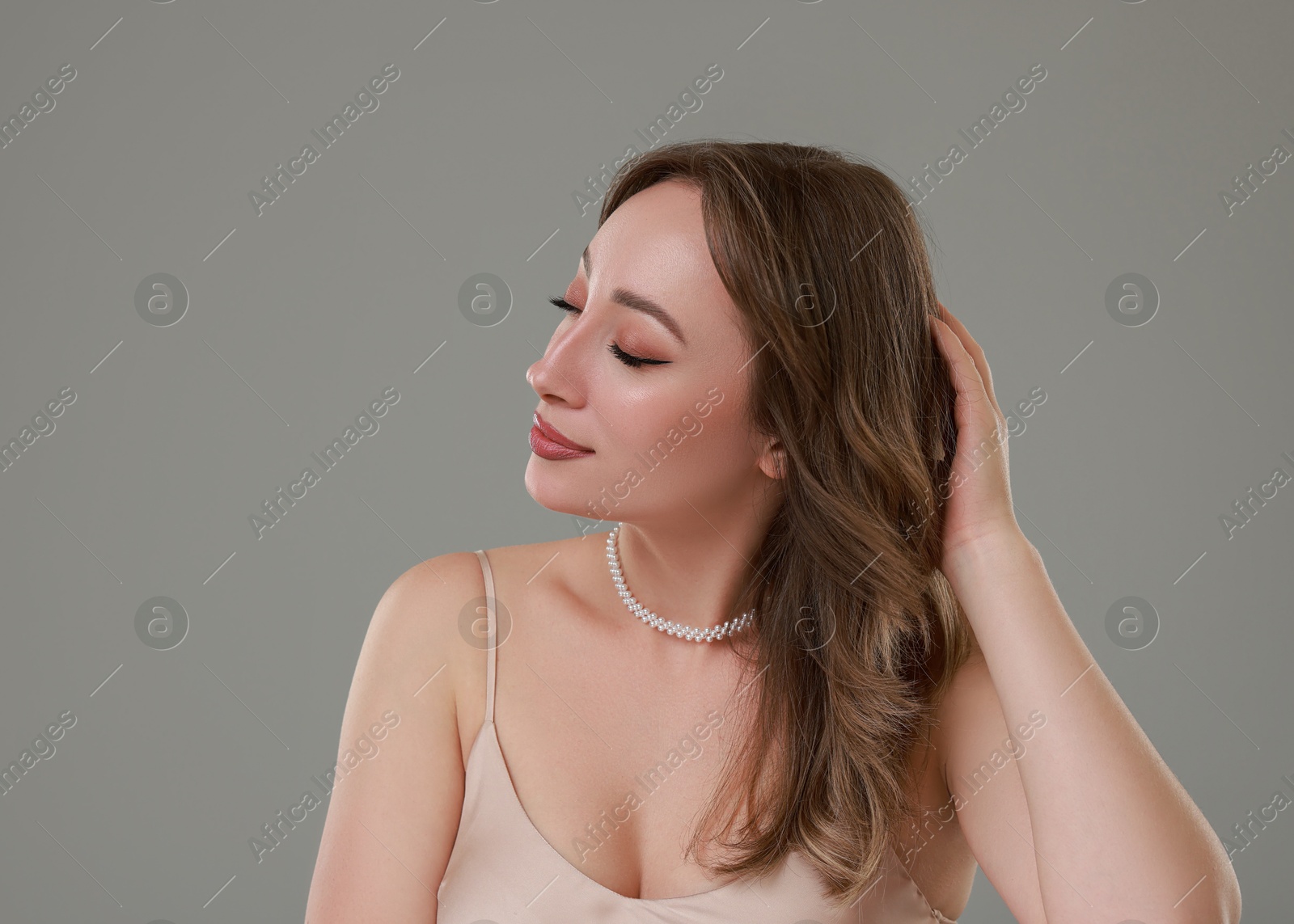 Photo of Attractive woman with stylish haircut on grey background