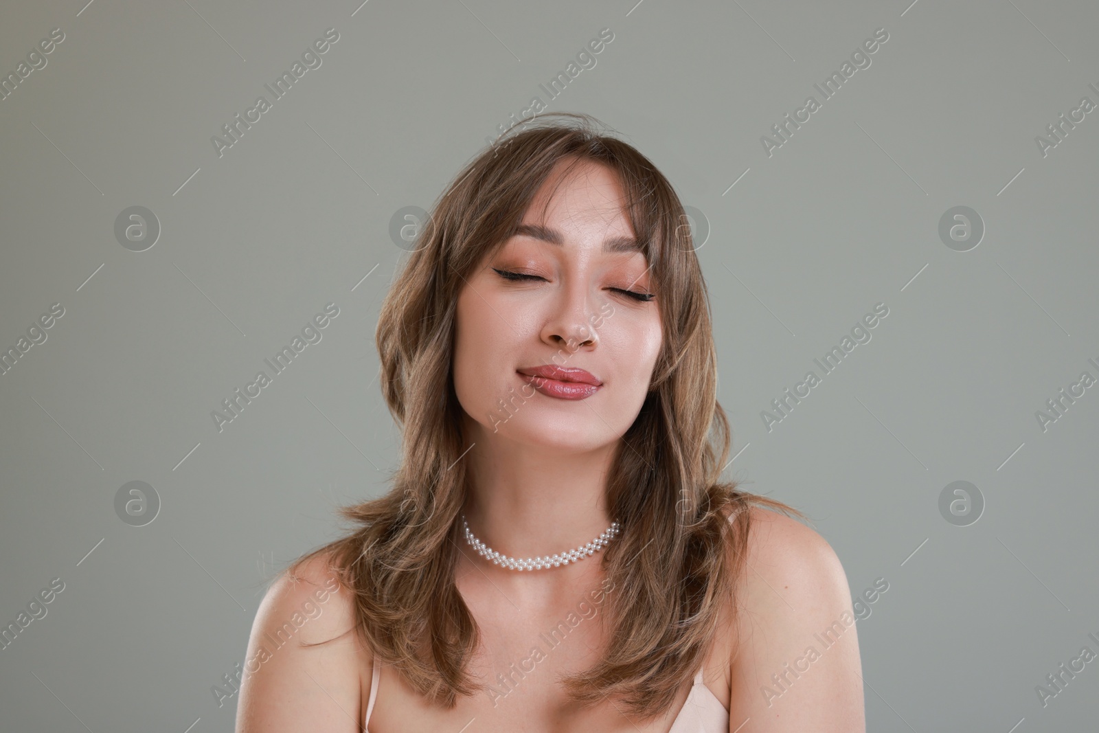 Photo of Attractive woman with stylish haircut on grey background