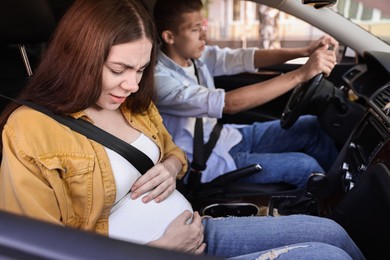 Photo of Pregnant woman travelling with her husband by car