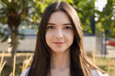 Photo of Portrait of beautiful teenage girl on city street