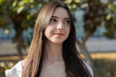 Photo of Portrait of beautiful teenage girl on city street