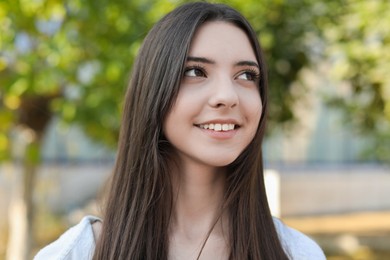 Portrait of beautiful teenage girl on city street