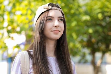 Photo of Portrait of teenage girl in stylish cap outdoors