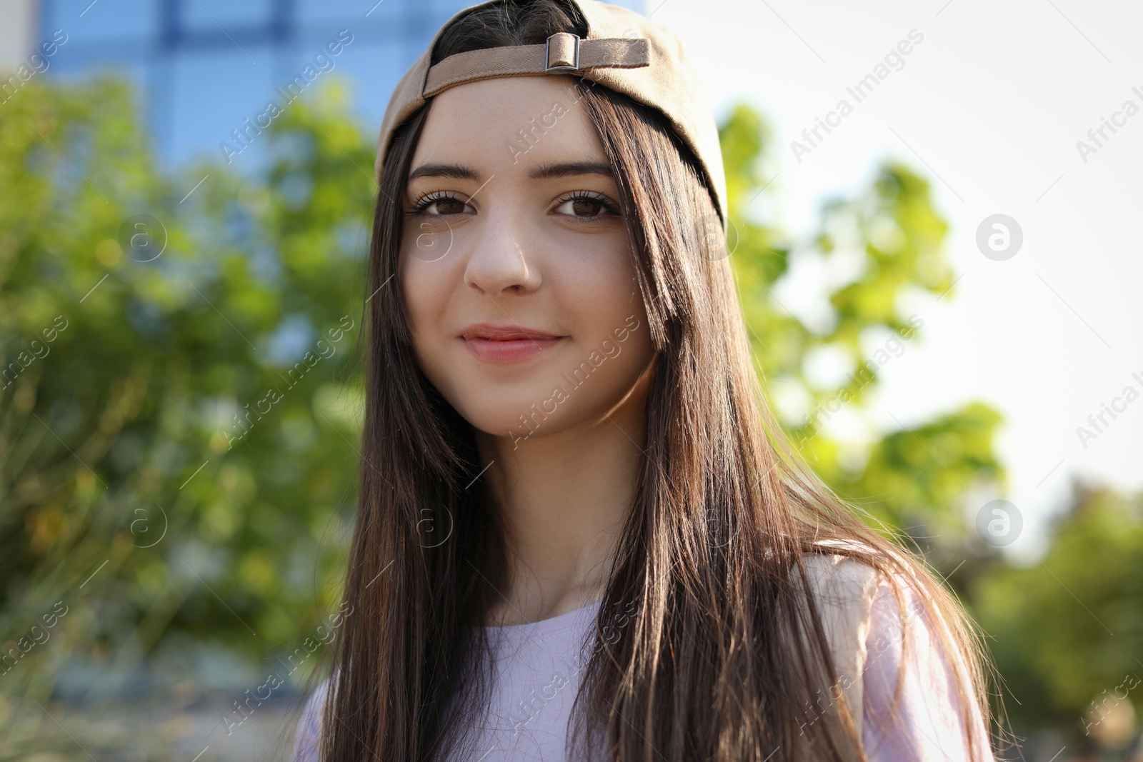 Photo of Portrait of teenage girl in stylish cap outdoors