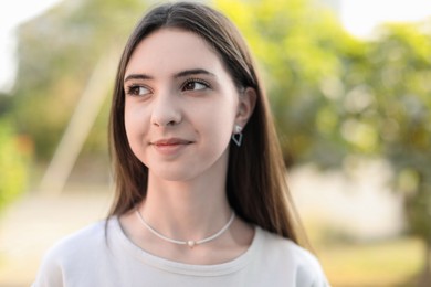 Photo of Portrait of beautiful teenage girl on city street