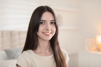 Photo of Portrait of happy teenage girl at home. Space for text